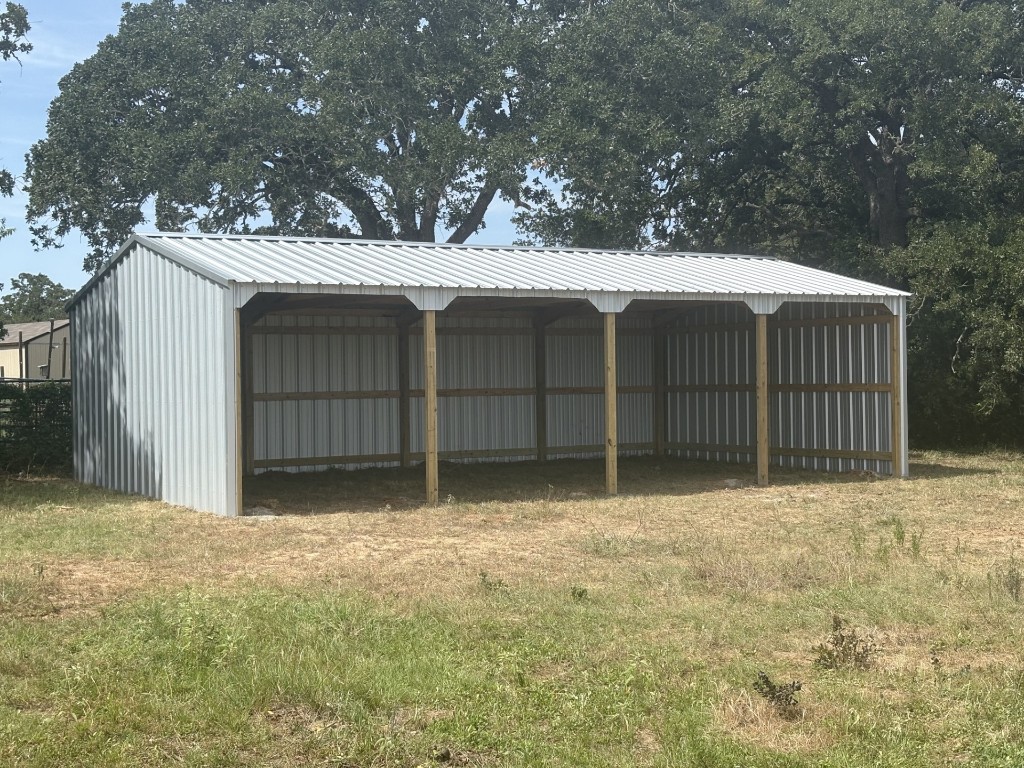 1430 Antioch Road Paige, TX 78659 - Photo 6 of 40 a front view of a house with a fence