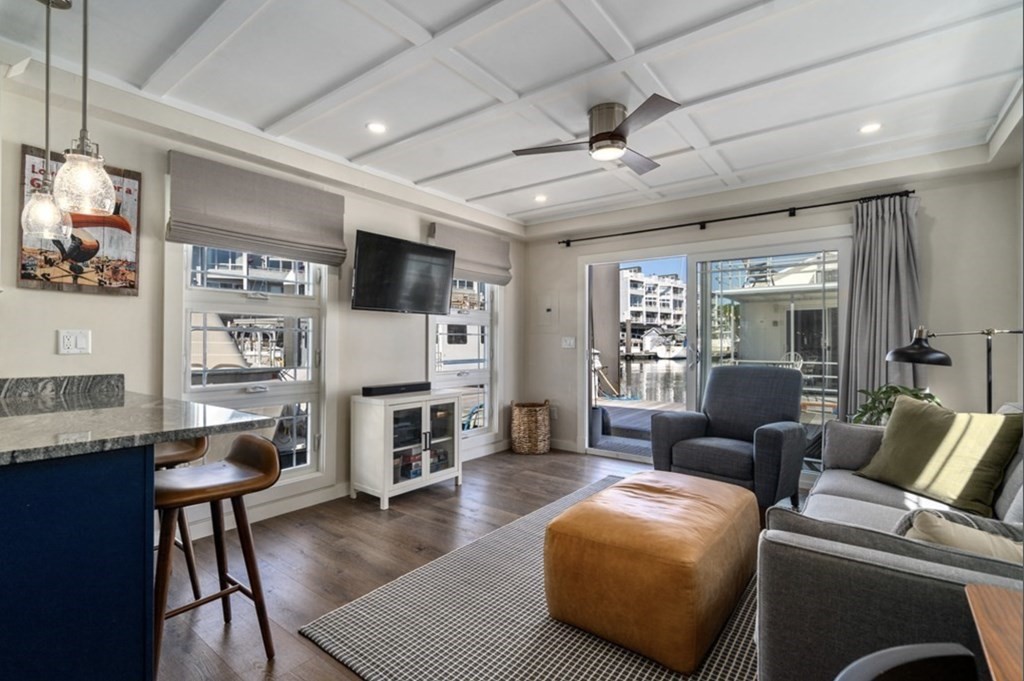 1 Pier 8, Unit BH Boston, MA 02129 - Photo 2 of 18 a living room with furniture and a flat screen tv