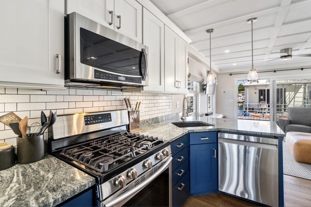 1 Pier 8, Unit BH Boston, MA 02129 - Photo 7 of 18 a kitchen with granite countertop a stove and a sink