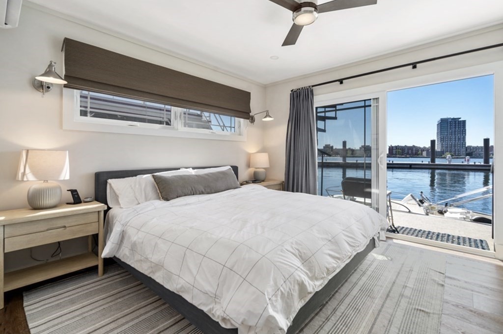 1 Pier 8, Unit BH Boston, MA 02129 - Photo 8 of 18 a bedroom with a bed and a large window