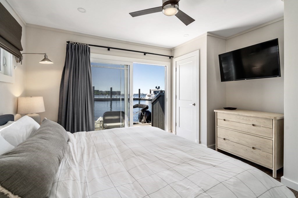 1 Pier 8, Unit BH Boston, MA 02129 - Photo 9 of 18 a bedroom with a bed and a flat tv screen
