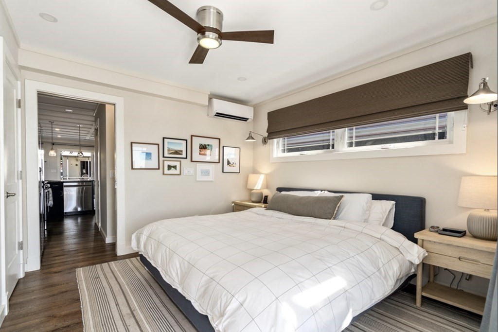 1 Pier 8, Unit BH Boston, MA 02129 - Photo 10 of 18 a bedroom with a large bed and a chandelier