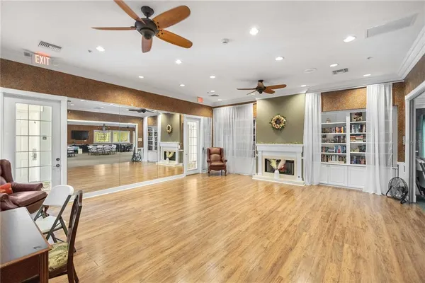 a view of a work space with furniture and a ceiling fan