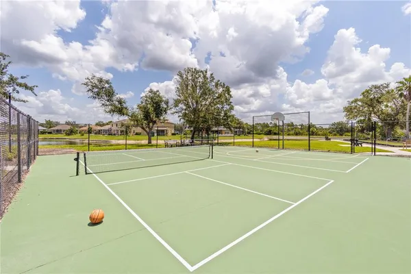a view of an outdoor space with swimming pool and trees in the background