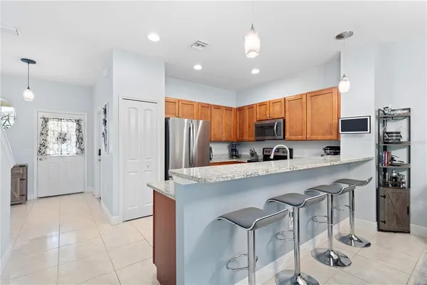 a large kitchen with a table and a a refrigerator