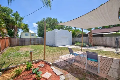 a view of a backyard with swimming pool
