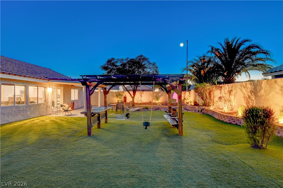 910 Cobblestone Cove Road North Las Vegas, NV 89081 - Photo 28 of 30 A private yard with a pergola and meticulously maintained landscaping offers a peaceful outdoor retreat.