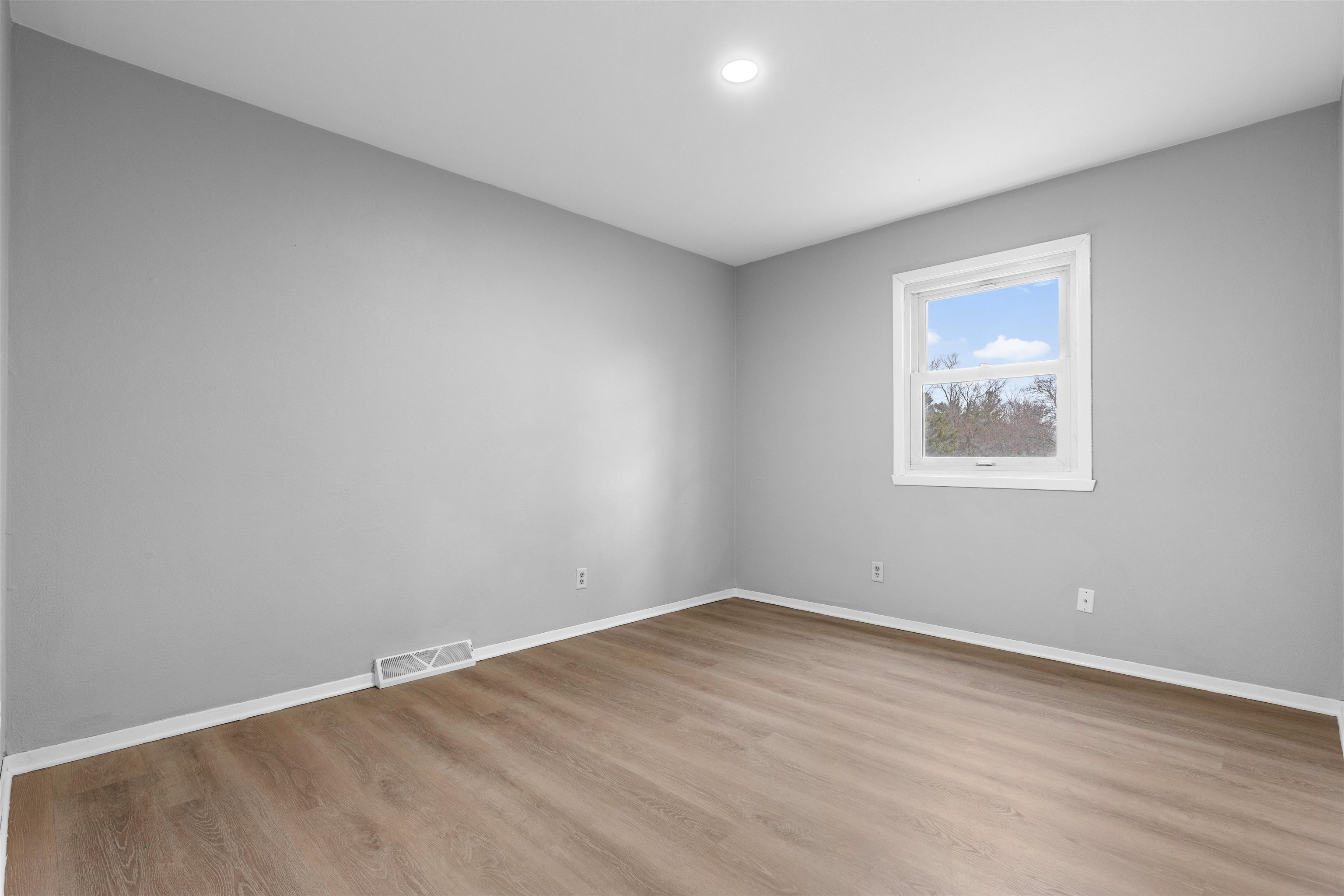 2718 Norway Pine Road Rockford, IL 61109 - Photo 11 of 12 a view of an empty room with wooden floor and a window