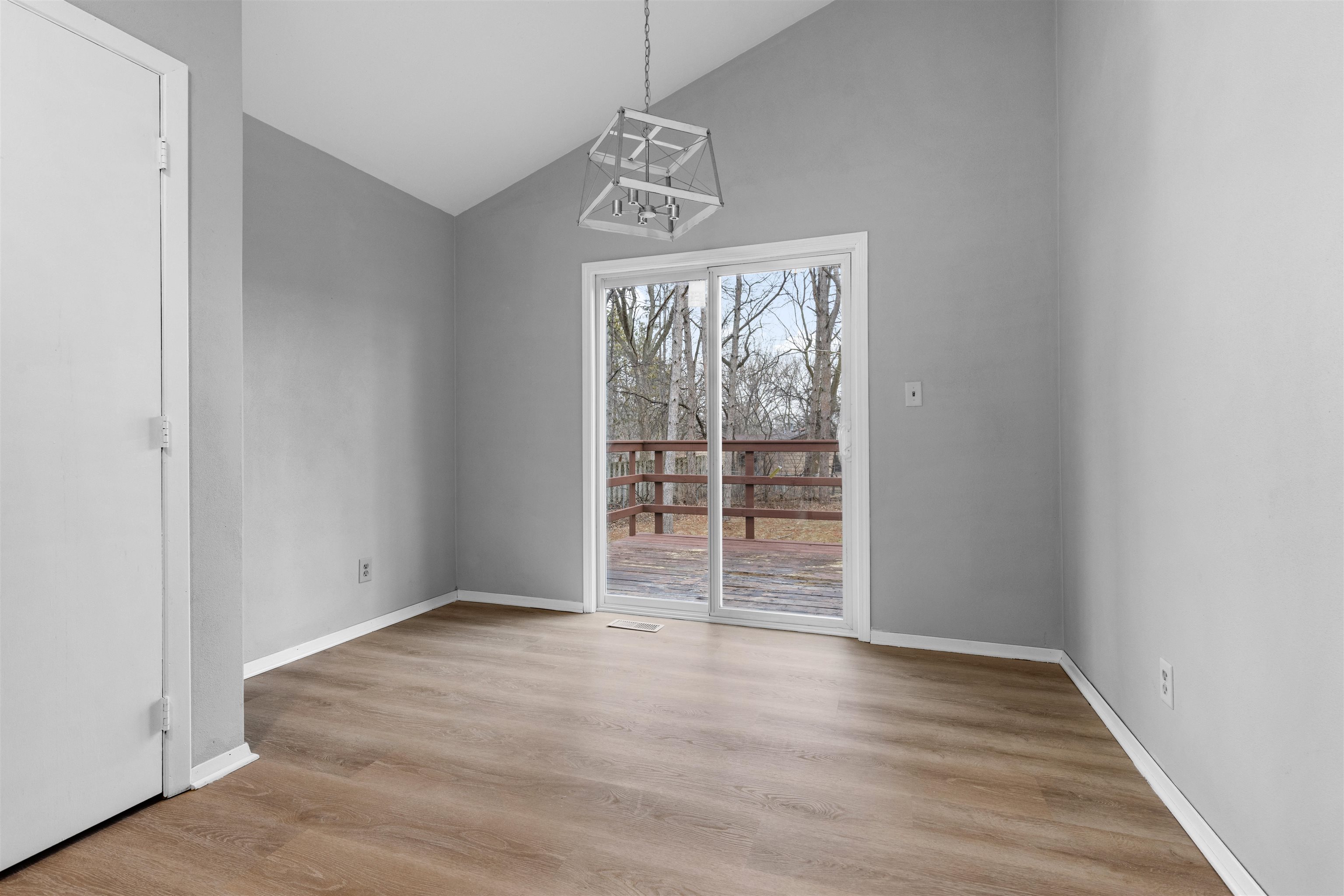 2718 Norway Pine Road Rockford, IL 61109 - Photo 6 of 12 an empty room with wooden floor cabinet and windows
