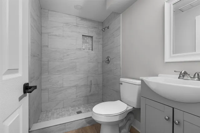 a bathroom with a sink toilet and a mirror