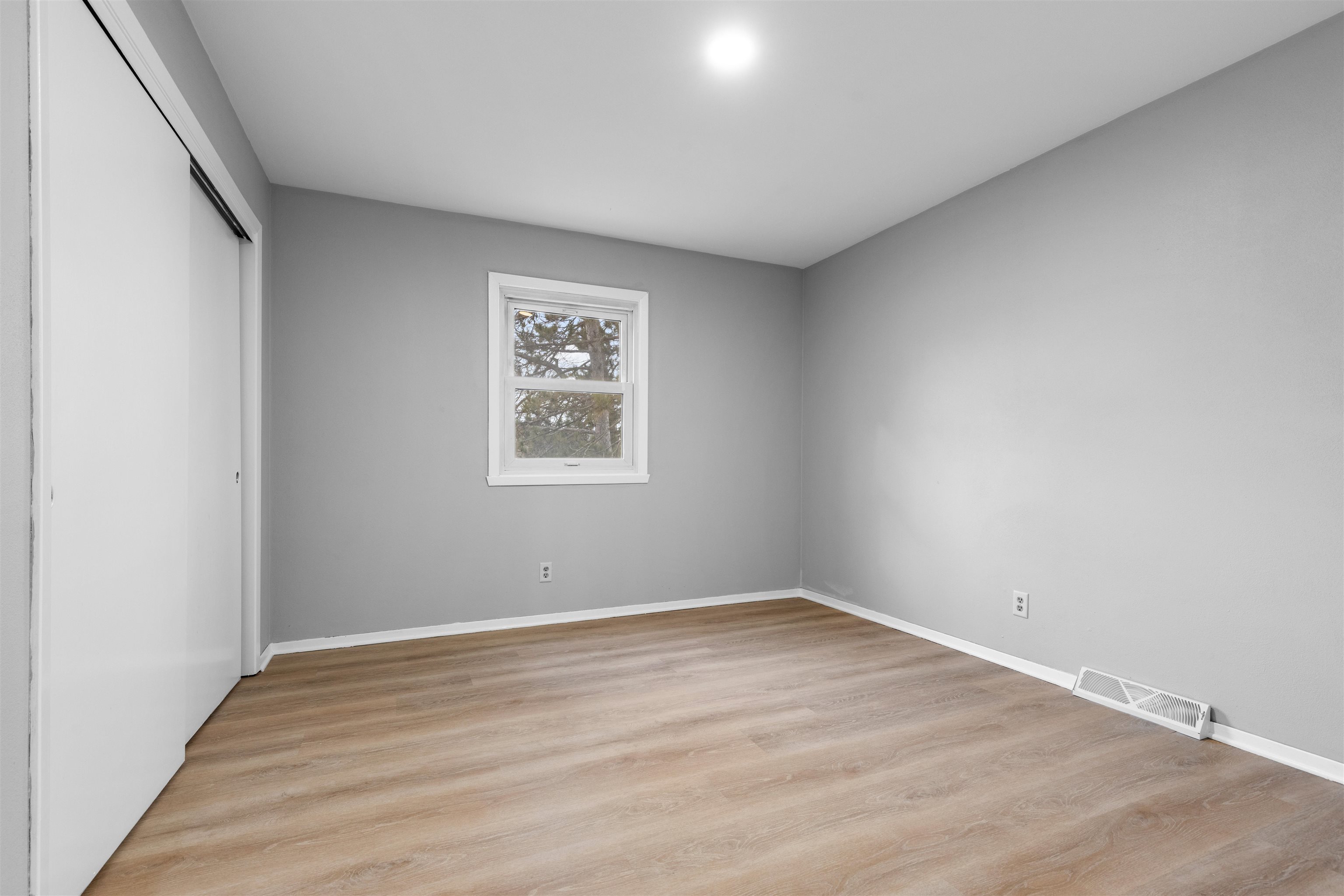 2718 Norway Pine Road Rockford, IL 61109 - Photo 8 of 12 wooden floor in an empty room with a window