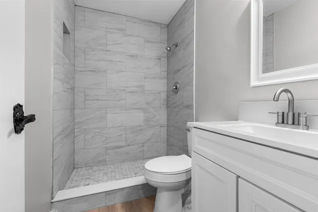 a bathroom with a sink toilet and shower