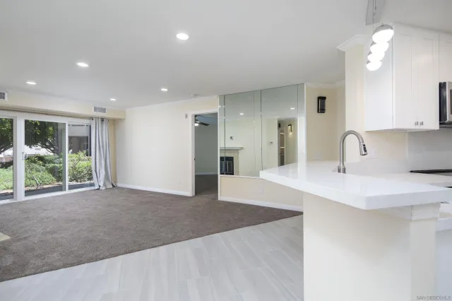 a view of a kitchen with a sink and a living room