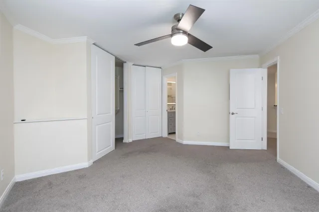 an empty room with ceiling fan