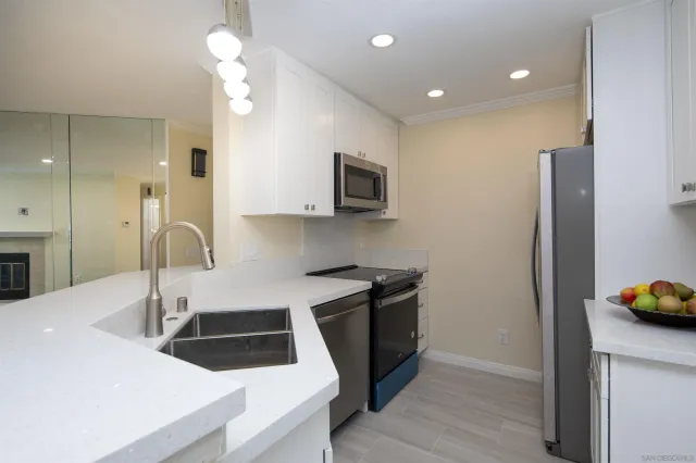 a kitchen that has a sink and a stove in it