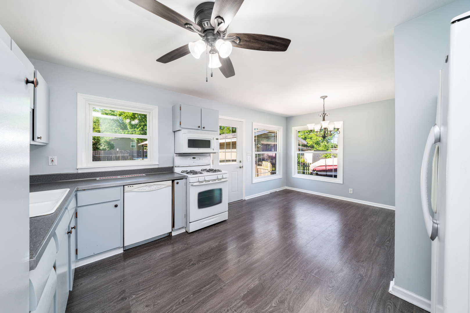 21 Briarcliff Road Montgomery, IL 60538 - Photo 9 of 20 a kitchen with stove and white cabinets with wooden floor