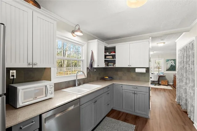 a kitchen with a sink cabinets and window