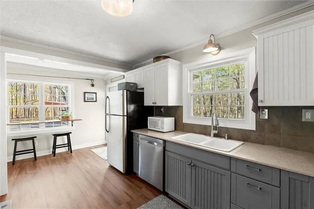 a kitchen with a sink appliances and cabinets