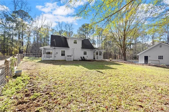 a view of a house with a yard covered with snow