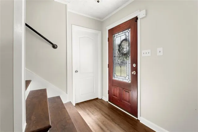 a view of an entryway with wooden floor