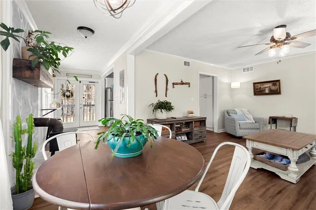 a living room with furniture flowerpot and a chandelier