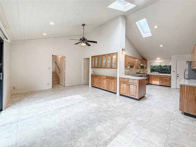 an empty room with a fan and a window