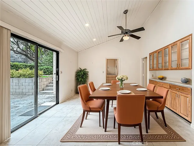 a bedroom with a bed tv and a window