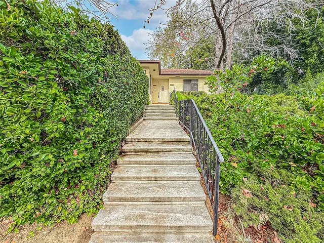 an empty room with a fireplace and a window