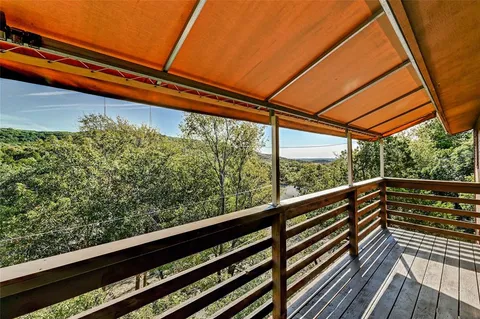 a view of balcony with wooden floor