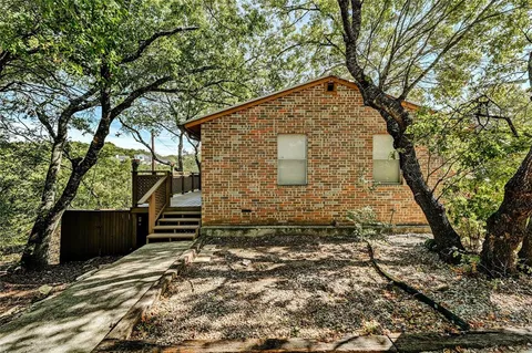 a backyard of a house with large trees