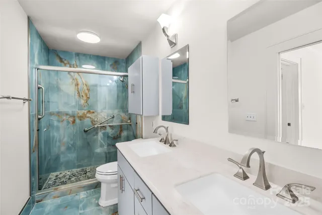 a bathroom with a sink toilet and shower