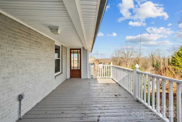 a view of a balcony with wooden floor