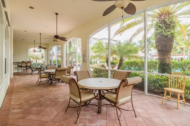 a dining room with furniture and a chandelier
