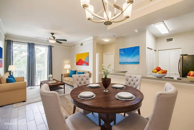 a view of a dining room with furniture and chandelier