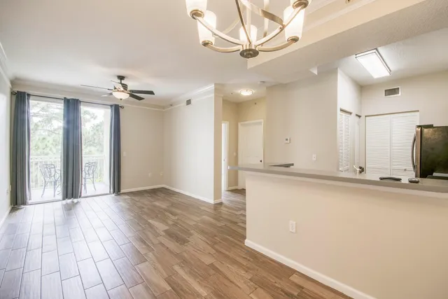 a view of a livingroom with kitchen and furniture