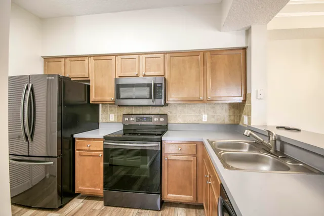 a kitchen with a sink stove and refrigerator