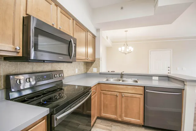 a kitchen with a stove microwave and sink