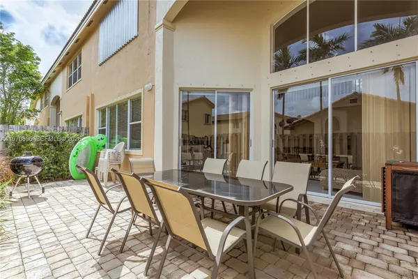 a view of a patio with table and chairs and potted plants