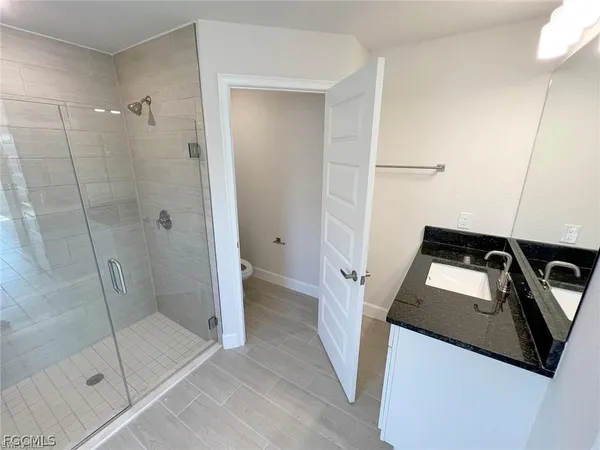 a bathroom with a shower and toilet