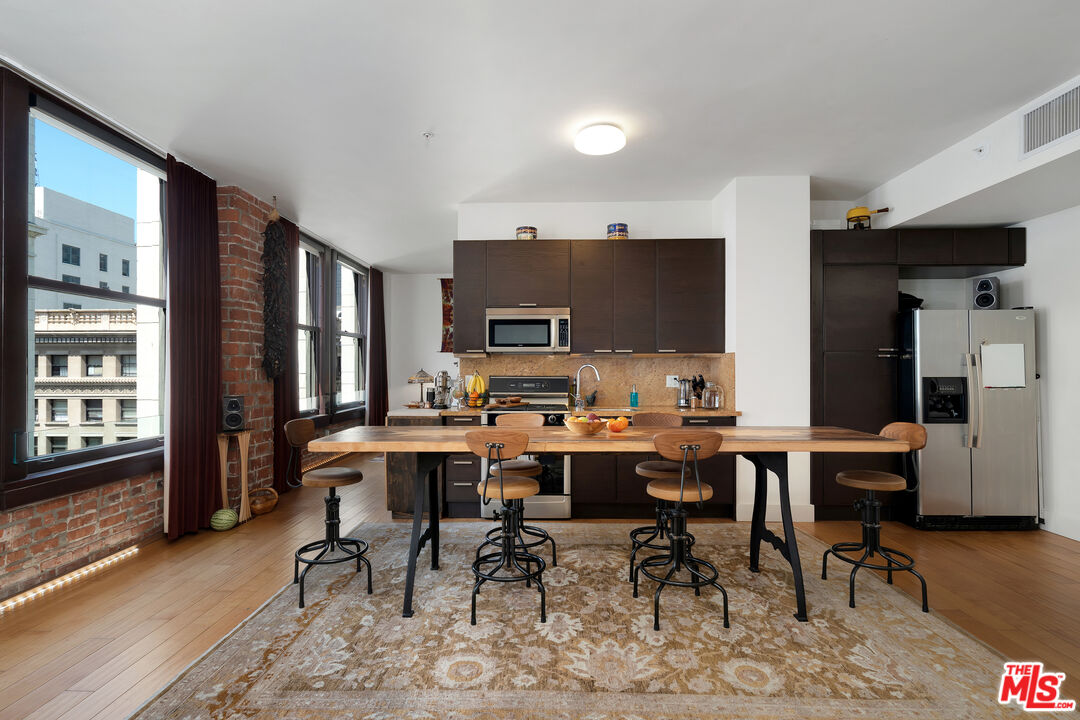a view of a dining room with furniture window and wooden floor
