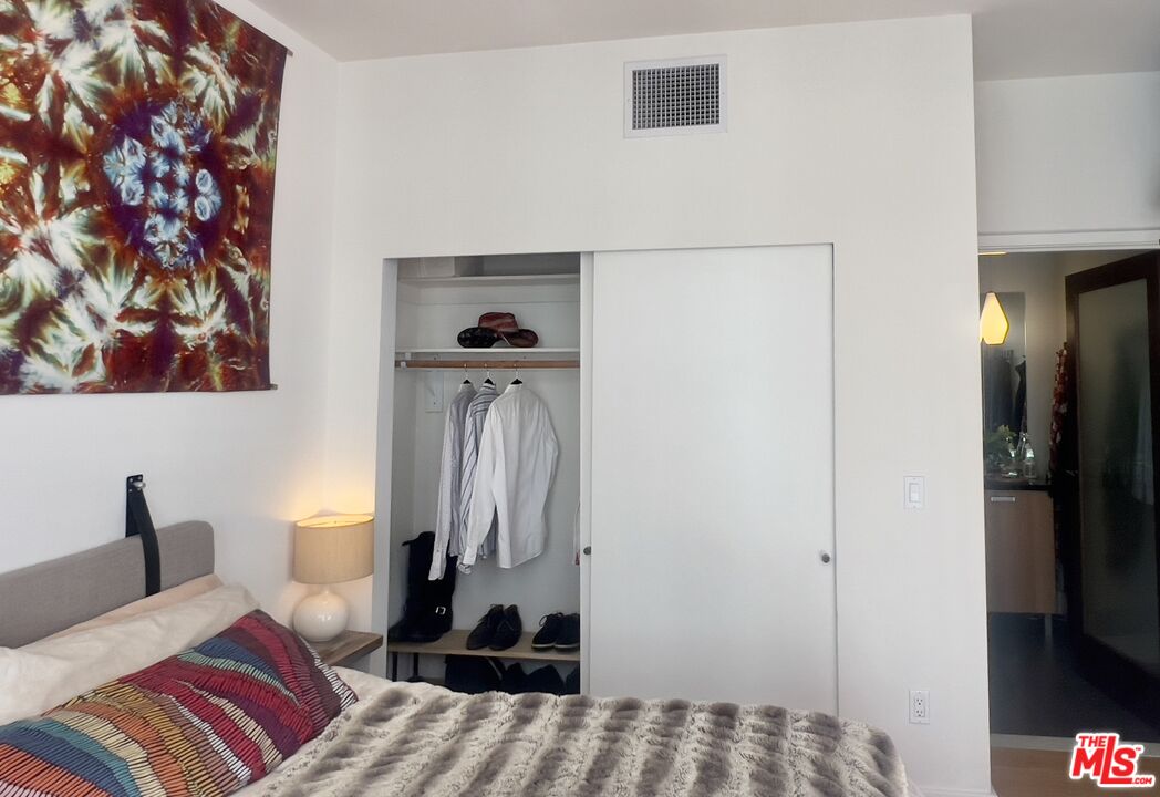 460 South Spring Street, Unit 813 Los Angeles, CA 90013 - Photo 11 of 26 a bedroom with a bed and a television