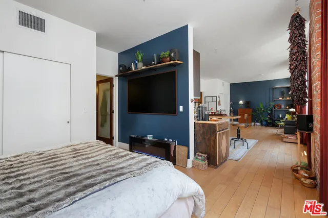 a bed room with a bed and a television