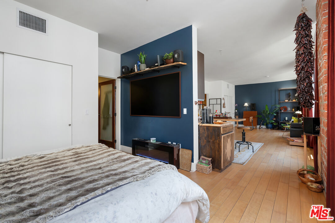 460 South Spring Street, Unit 813 Los Angeles, CA 90013 - Photo 13 of 26 a bed room with a bed and a television