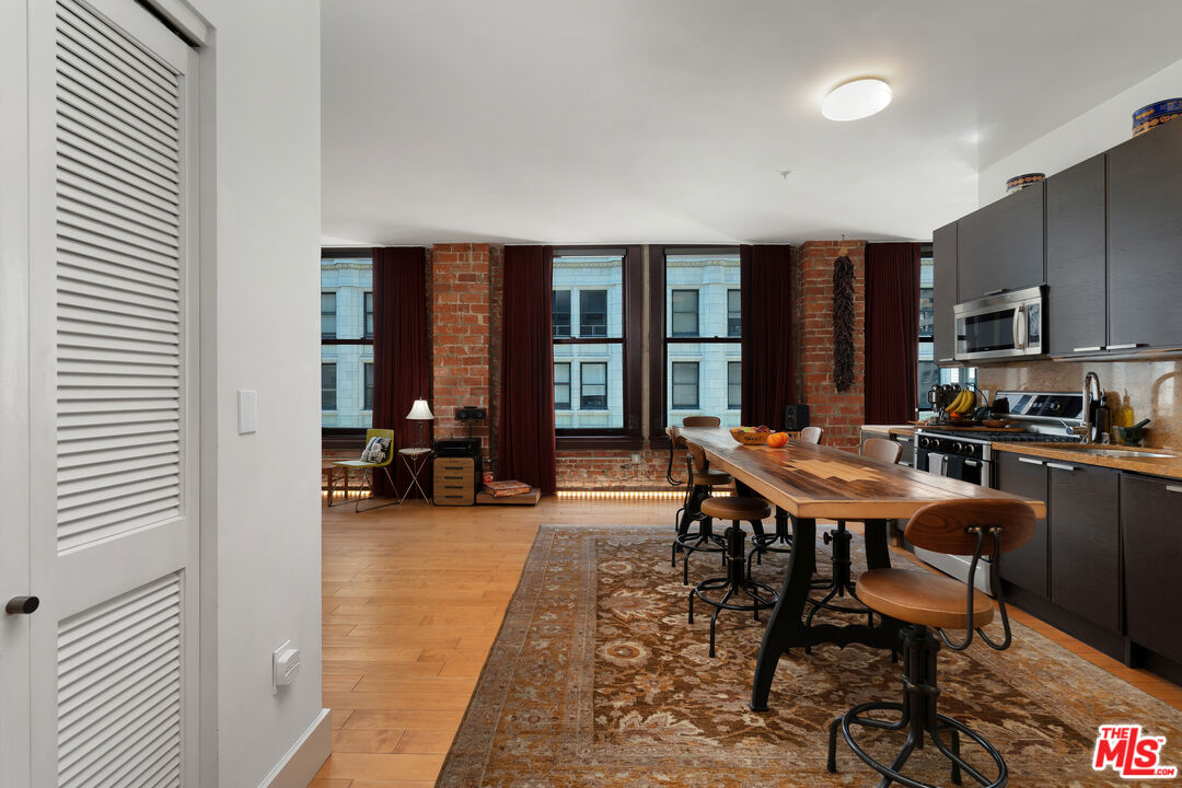 460 South Spring Street, Unit 813 Los Angeles, CA 90013 - Photo 2 of 26 a view of a dining room with furniture window and outside view