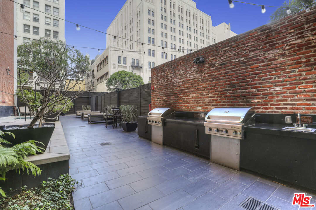 460 South Spring Street, Unit 813 Los Angeles, CA 90013 - Photo 23 of 26 a view of a patio with couches chairs and potted plants