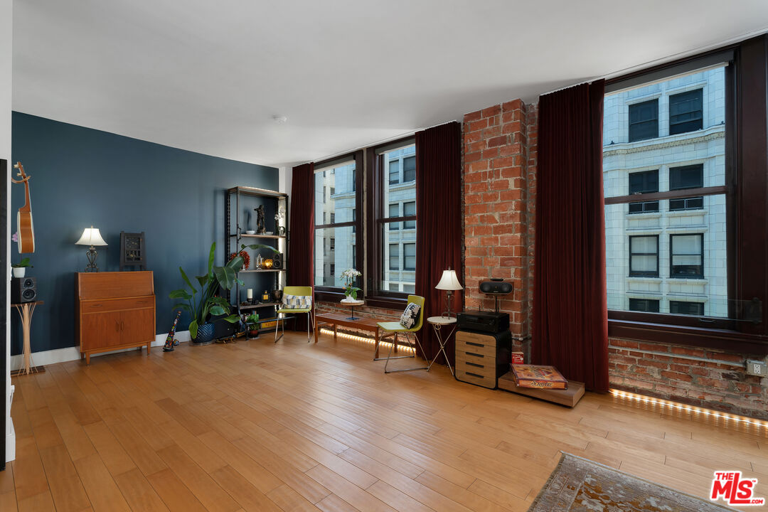 460 South Spring Street, Unit 813 Los Angeles, CA 90013 - Photo 5 of 26 a living room with furniture and large windows