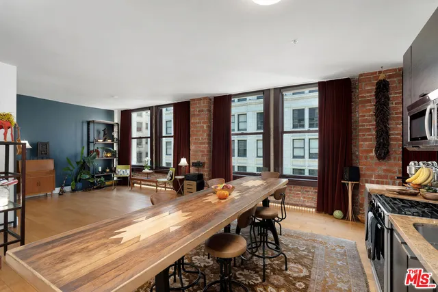a room with furniture a large window and a view of living room