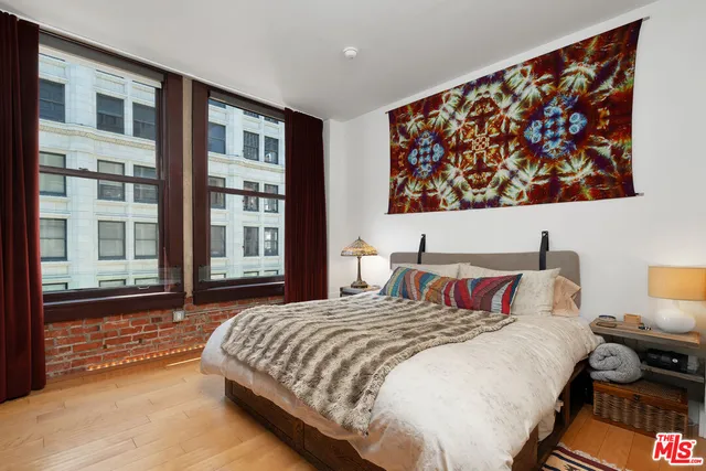 a bedroom with a bed and a night stand