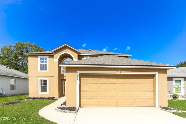 a front view of a house with a garden
