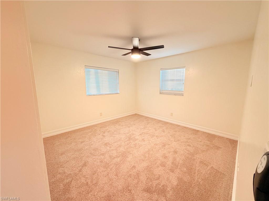 9017 Pineapple Road Fort Myers, FL 33967 - Photo 15 of 24 Empty room with healthy amount of natural light and light colored carpet